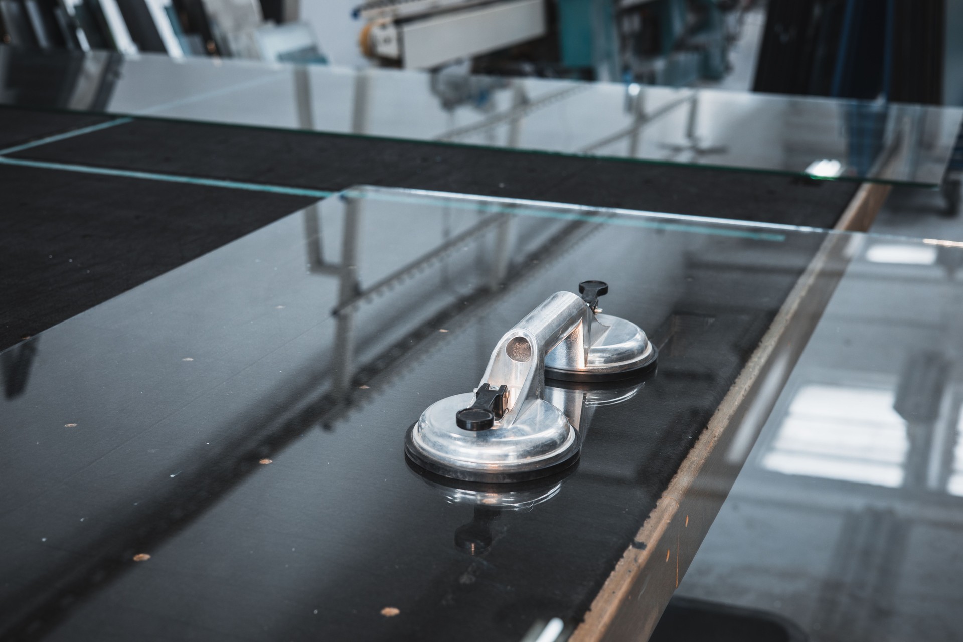 Glass suction cup attached to a large glass pane, Specialized industrial tool, Glass works